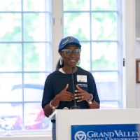 Women speaks into microphone at podium